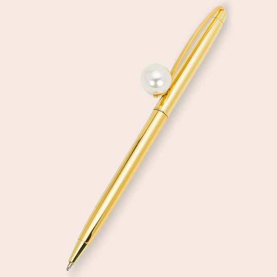 One golden pen with a pearl detail by Pearl Spark Pages