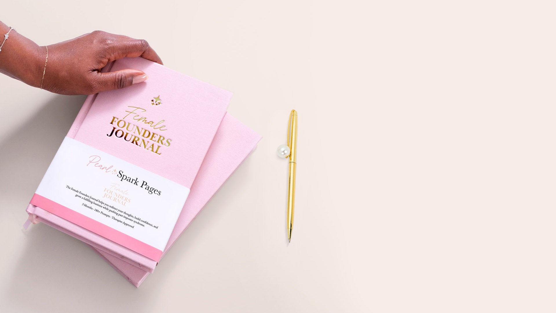 Close-up of a woman holding the blush pink linen Female Founders Journal by Pearl Spark Pages, a tool for empowered women entrepreneurs.