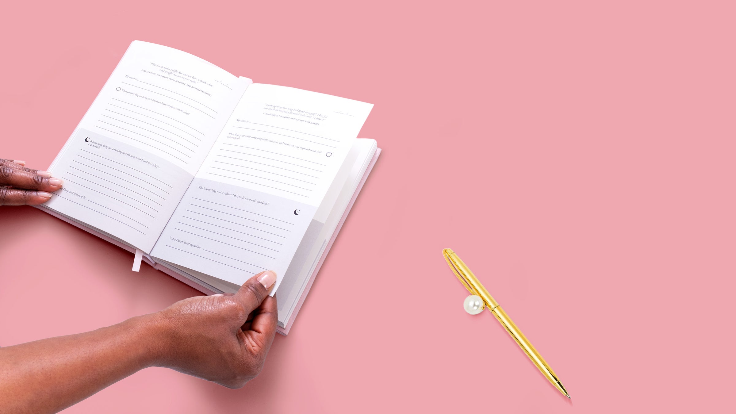 A woman's hands opening the Female Founders Journal on a page featuring morning and evening prompts. A golden pen with a pearl embellishment sits on the right side.